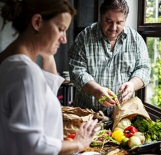 Hispanic middle aged couple preparing a meal